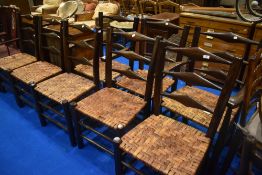 A set of eight (six plus two) stained frame ladder back chairs having woven cane seats
