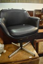 A vintage vinyl swivel chair