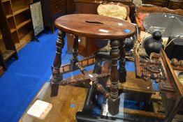 A traditional stool having oval top and turned frame, width approx. 41cm