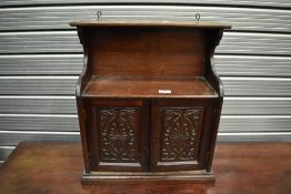 A Victorian mahogany wall cupboard having carved doors, width approx 43cm