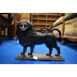 A vintage cast iron doorstop modelled as lion