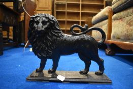 A vintage cast iron doorstop modelled as lion