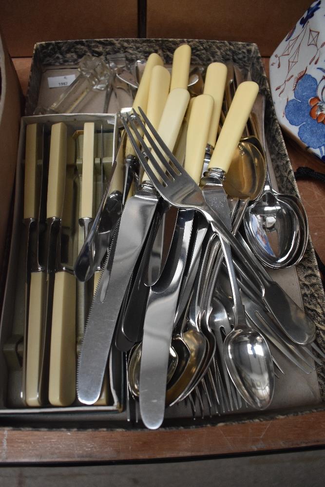 A collection of flatware including boxed butter knives and bone handled knives etc.
