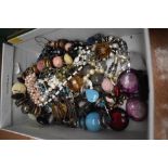 A box of miscellaneous costume jewellery, including polished stone necklaces, a shades of autumn