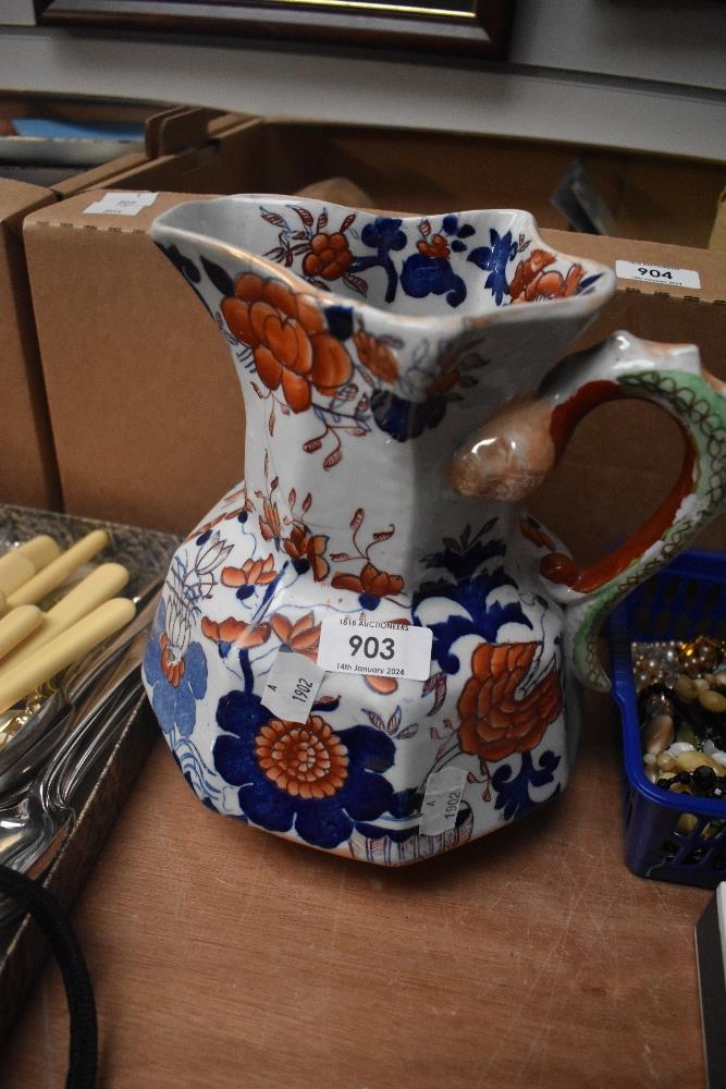 A large Masons Ironstone jug, having serpent handle and blue and rust foliate decoration.