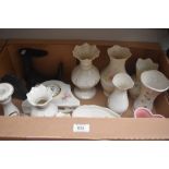 A carton containing a selection of Belleek and Donegal china vases, posy pots, clocks and