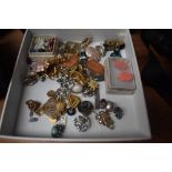 An assorted collection of costume jewellery, including daisy design earrings, an eastern filligree