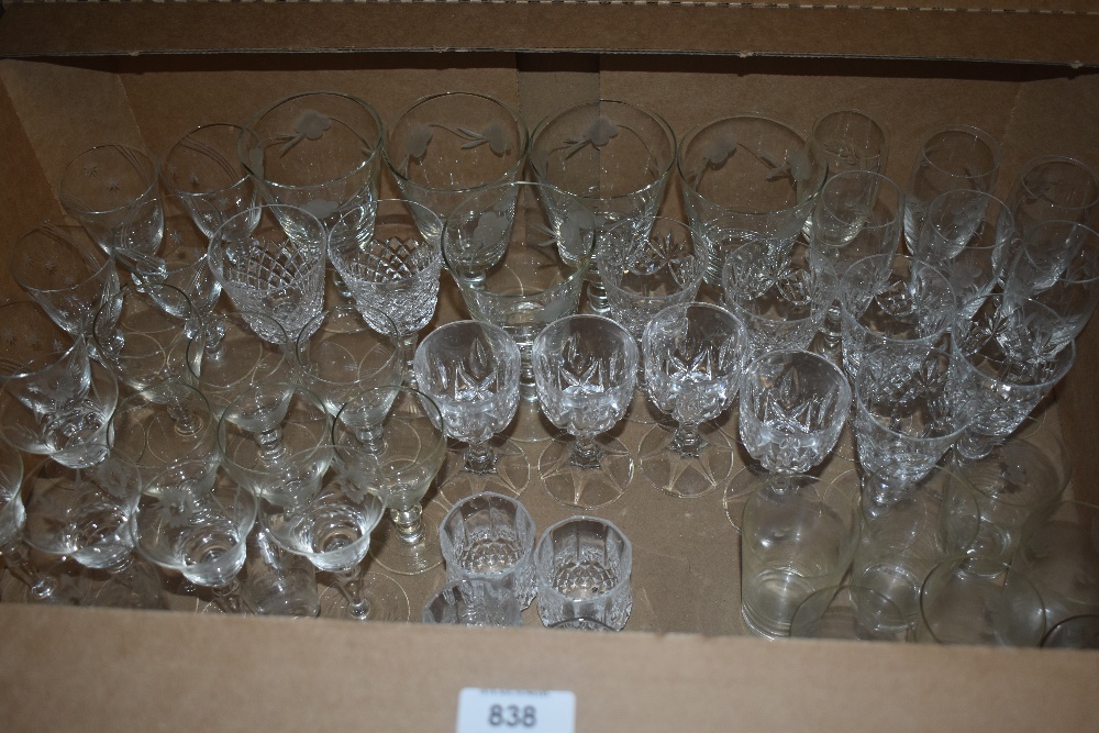 A carton containing a selection of cut and etched glass wine and spirit glasses.