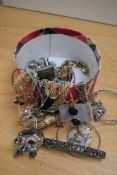 A tub of assorted costume jewellery, including yellow and white metal chains