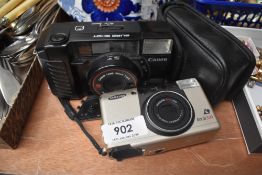 A Canon Sureshot with Canon 38mm lens and a Samsung Rocas 300 camera (as Found)