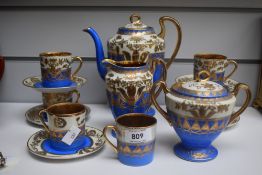 A Japanese Samurai china 14 piece coffee set with blue ground and gilt decoration.