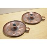 A pair of unsigned Keswick School of Industrial Art (KSIA) Arts & Crafts copper chamber sticks, with