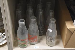 A collection of vintage glass milk bottles with adverts, of Kilbride, Longridge, Knottend interest