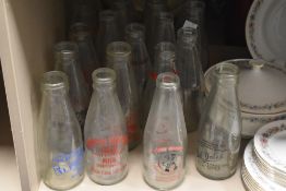 A collection of vintage advertising milk bottles, including Darwen, Abbeytown and Lindale interest.