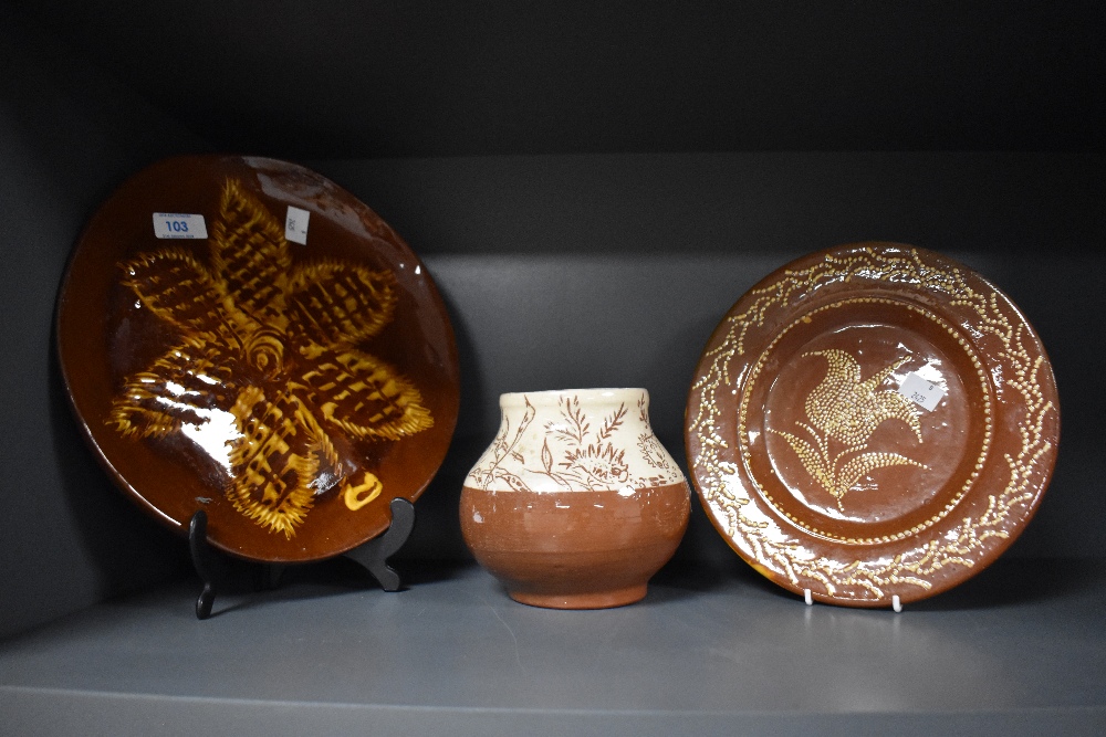 Three pieces of slipware studio pottery, to include slipware plate, and a two tone vase with incised