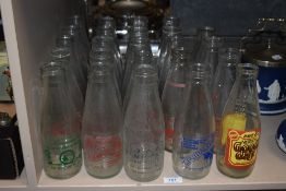 A collection of vintage advertising milk bottles, including Millom, Blackburn, Dumfries interest