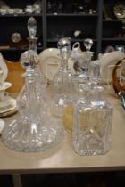 A selection of vintage decanters, including cut glass and etched examples.
