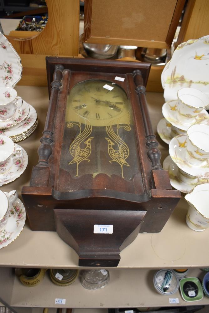A traditionally styled wooden cased 'Maxim' wall clock, having 31 day movement.