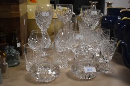 An assortment of glass ware, including cut glass wine glasses, tumblers, brandy glasses etc.