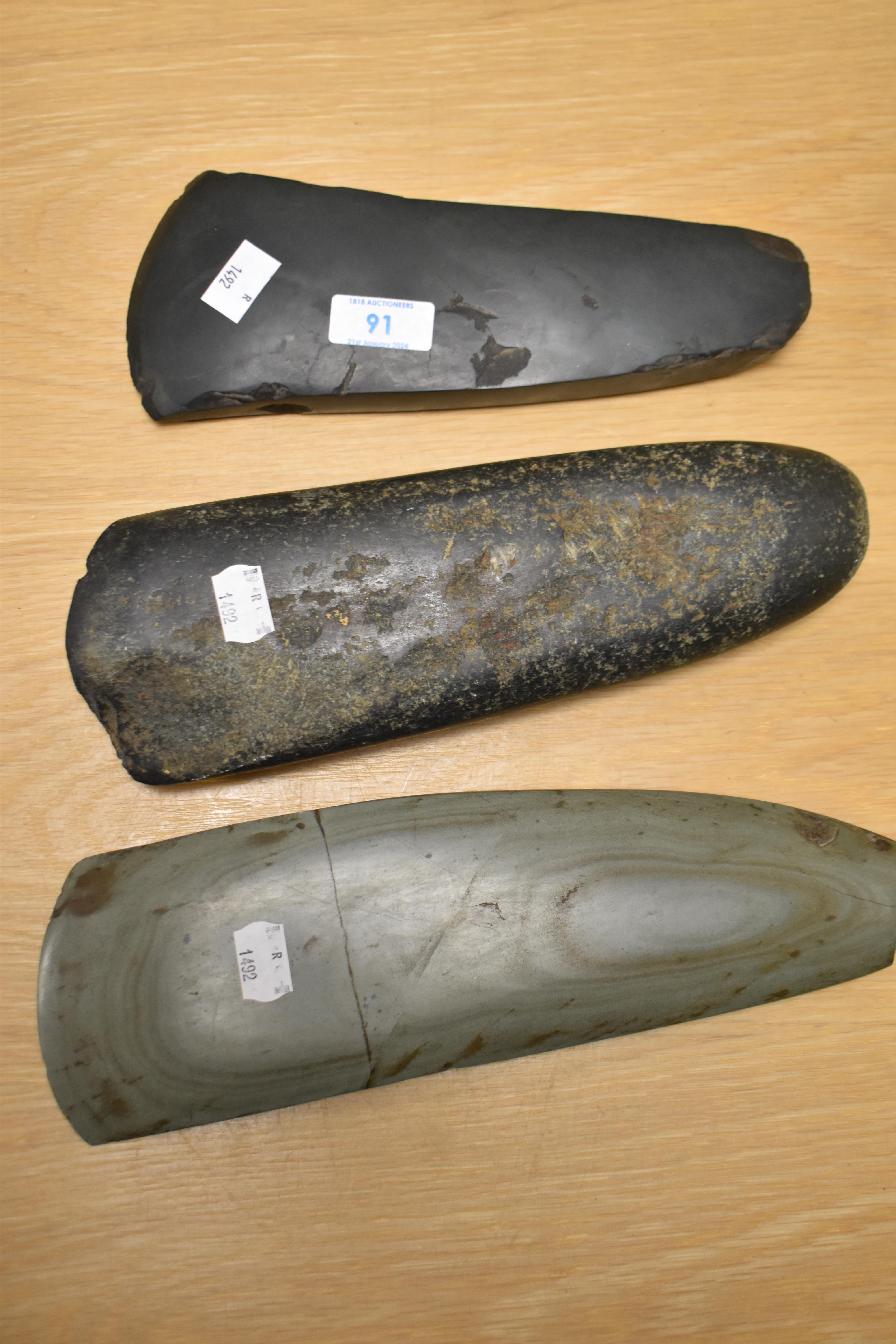 Three Oceanic stone axe heads, of Papua New Guinea origin, the largest measures 25cm long