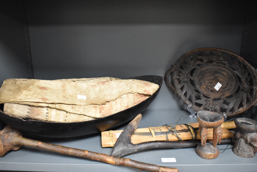 An assorted collection of primitive African tools and carvings, including a hardwood club