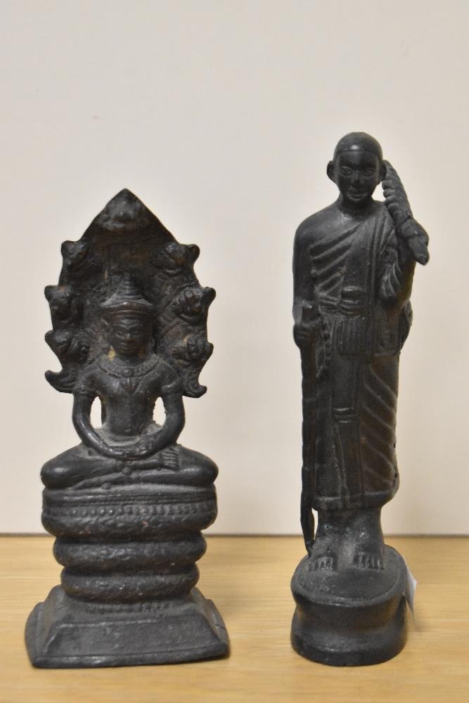Two antique cast metal Buddha ornaments, to include one of a Sivali Buddhist monk, the largest