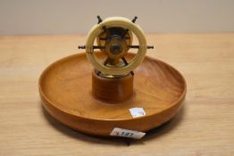 A mid century ships wheel nut cracker, mounted over turned elm or similar wood bowl.