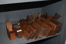 Two vintage wood planing tools and a selection of wooden moulding planes