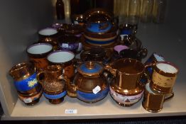 A selection of Victorian copper lustre glazed cups, saucers, teapot, jugs etc.