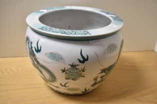 A 20th Century Chinese porcelain jardiniere, decorated in shades of green and gilt, illustrating the