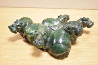 A detailed Chinese green stone hippo group carving, possibly Nephrite, measuring 22cm long