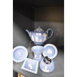 An assorted collection of Wedgwood blue jasperware, to include a teapot, table lighter, and flared