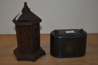 Two vintage metal money boxes, one of cast metal with bird decoration in the form of a post box.