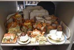 A large collection of vintage cottage interest ceramics, including teapots and biscuit barrel.