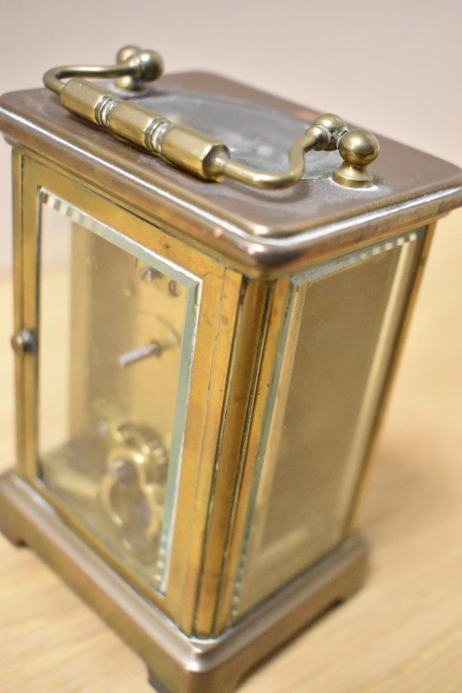 A 19th Century brass cased carriage clock, with enamelled Roman dial, measuring 12cm tall - Image 3 of 4