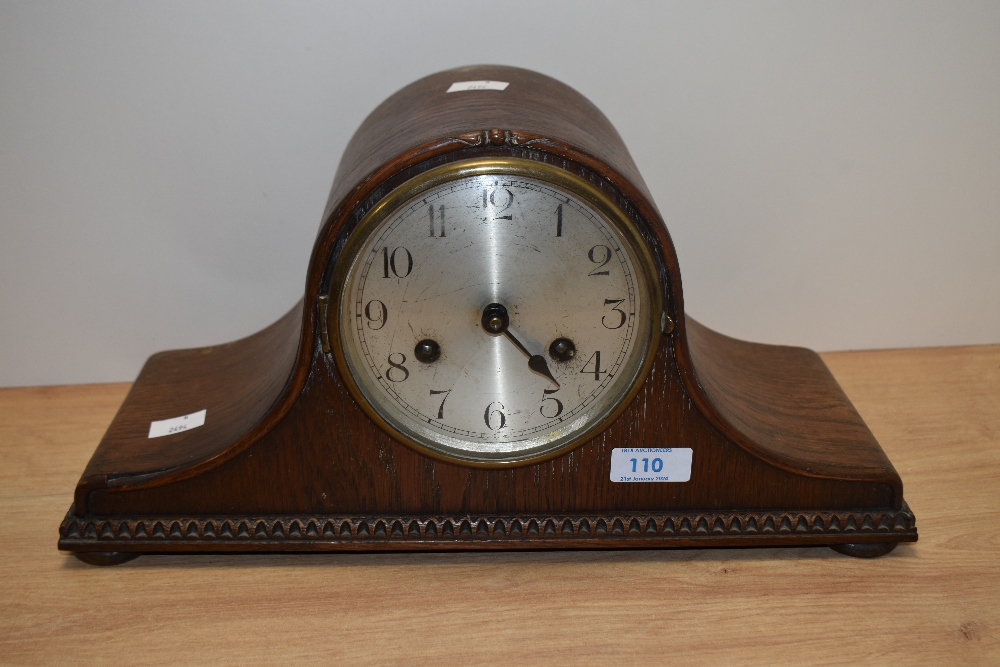 An early 20th Century Napoleon hat mantel clock, oak cased, and having silvered Arabic dial, with