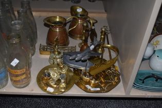 An assortment of brass toasting forks, candlesticks and copper and brass jugs, also included is a