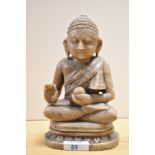 A 20th Century carved hard stone seated Thai Buddha, measuring 21cm tall