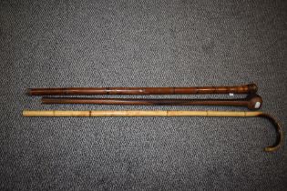 A South African knob kerri, a bamboo walking stick and similar can with carved oriental decoration.