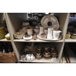 A large collection of Poole Pottery in fawn and coffee colour way, including toast rack, cups and