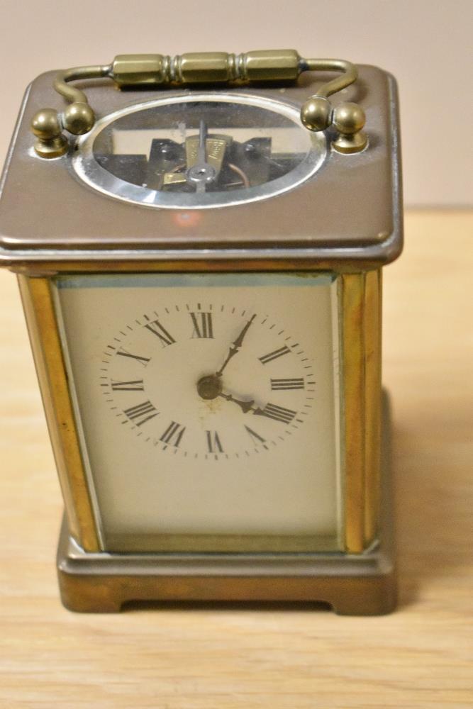 A 19th Century brass cased carriage clock, with enamelled Roman dial, measuring 12cm tall