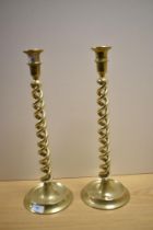 A pair of 19th/20th Century brass twist stem candlesticks, measuring 43cm