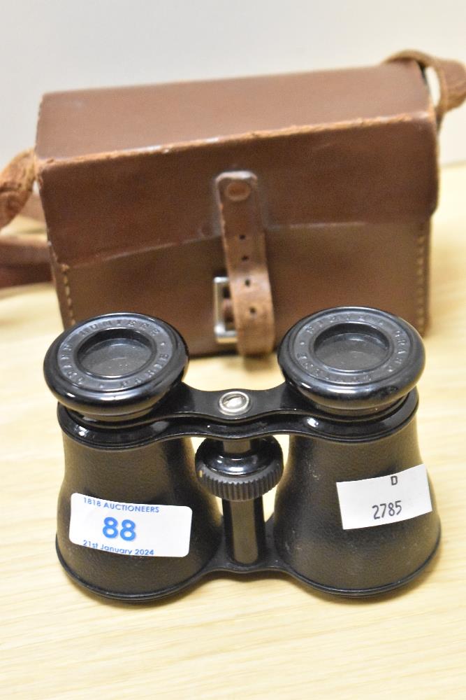 A pair of late 19th/early 20th Century Grand Lumiere of Paris binoculars, with tan case