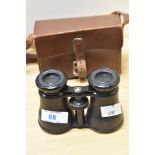 A pair of late 19th/early 20th Century Grand Lumiere of Paris binoculars, with tan case