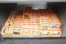 A shelf of Lledo Days Gone die-casts, Vintage Cars and Trucks, 90+, all in window display boxes