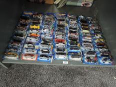 A shelf of Mattel Hot Wheels die-casts, 2003 period onwards, 70 in total, all on bubble display