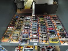 A shelf of modern Matchbox die-casts, 2011 period, 70 in total, all on bubble display cards, all