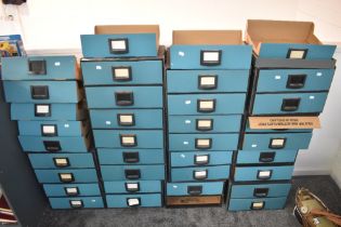A large collection of Bankers Box interlocking card storage units with extra drawers present