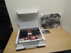 A volume, Taschen, Greatest Of All Time A Tribute to Muhammad Ali, in outer card folding case