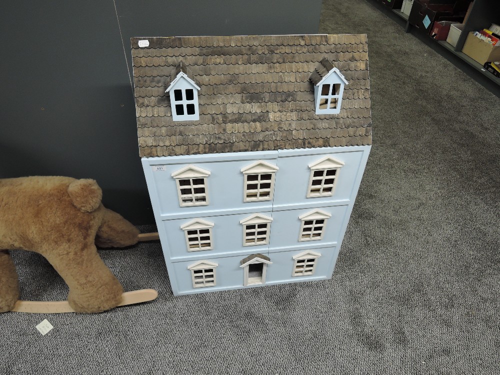 A modern wooden Three Storey Dolls House with converted loft space along with unfitted staircase and